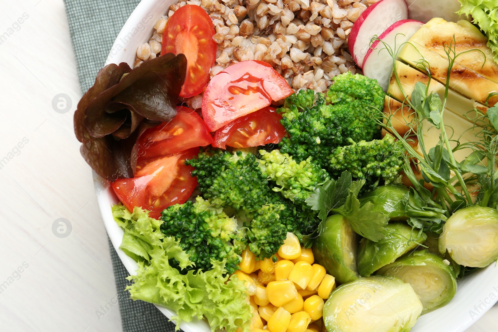 Photo of Healthy meal. Tasty products in bowl on white table, top view