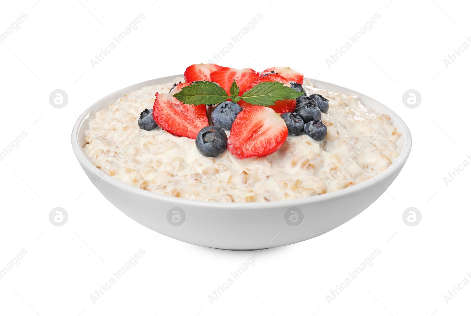 Photo of Tasty boiled oatmeal with berries in bowl isolated on white