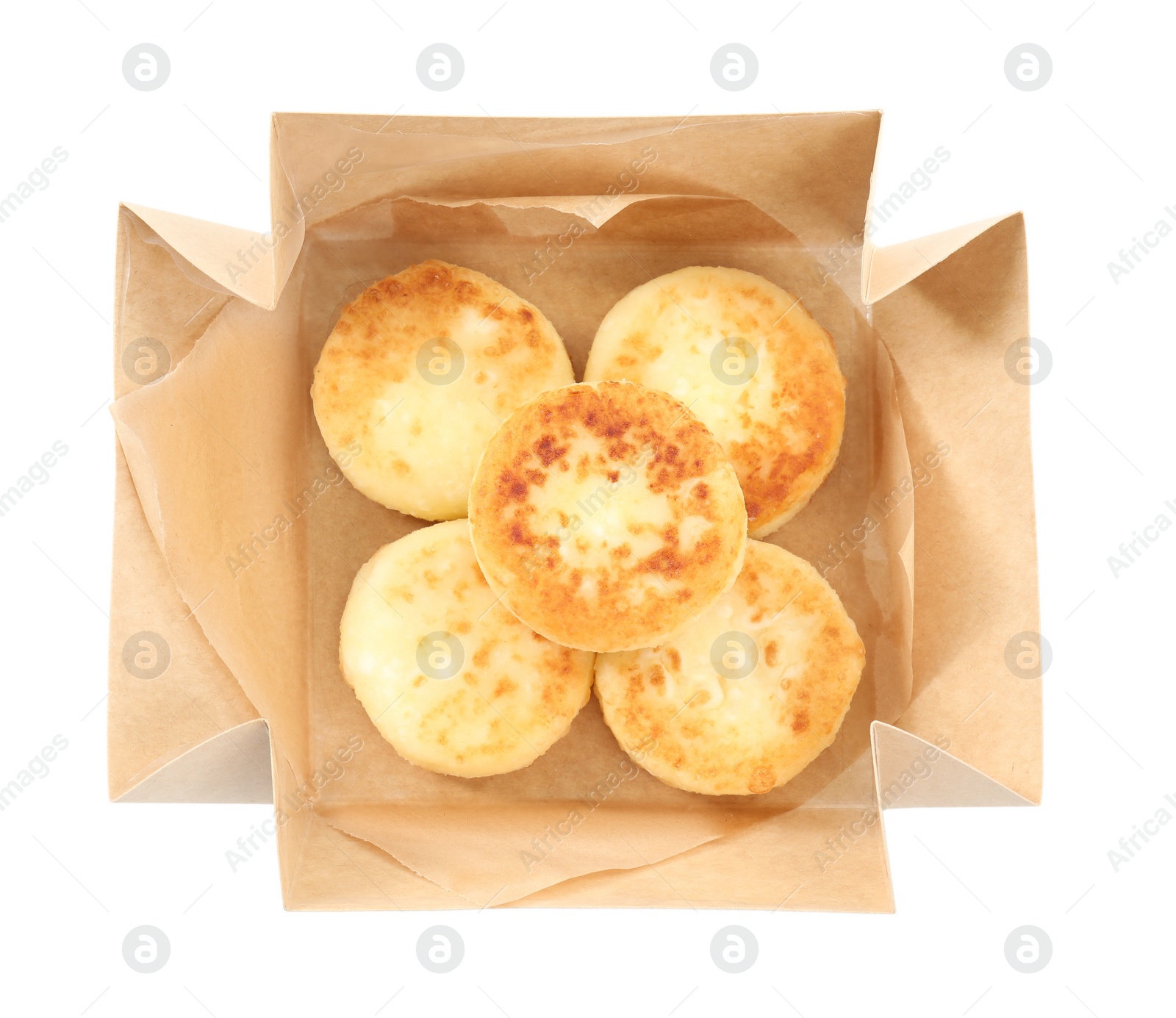 Photo of Cottage cheese pancakes in paper box isolated on white, top view