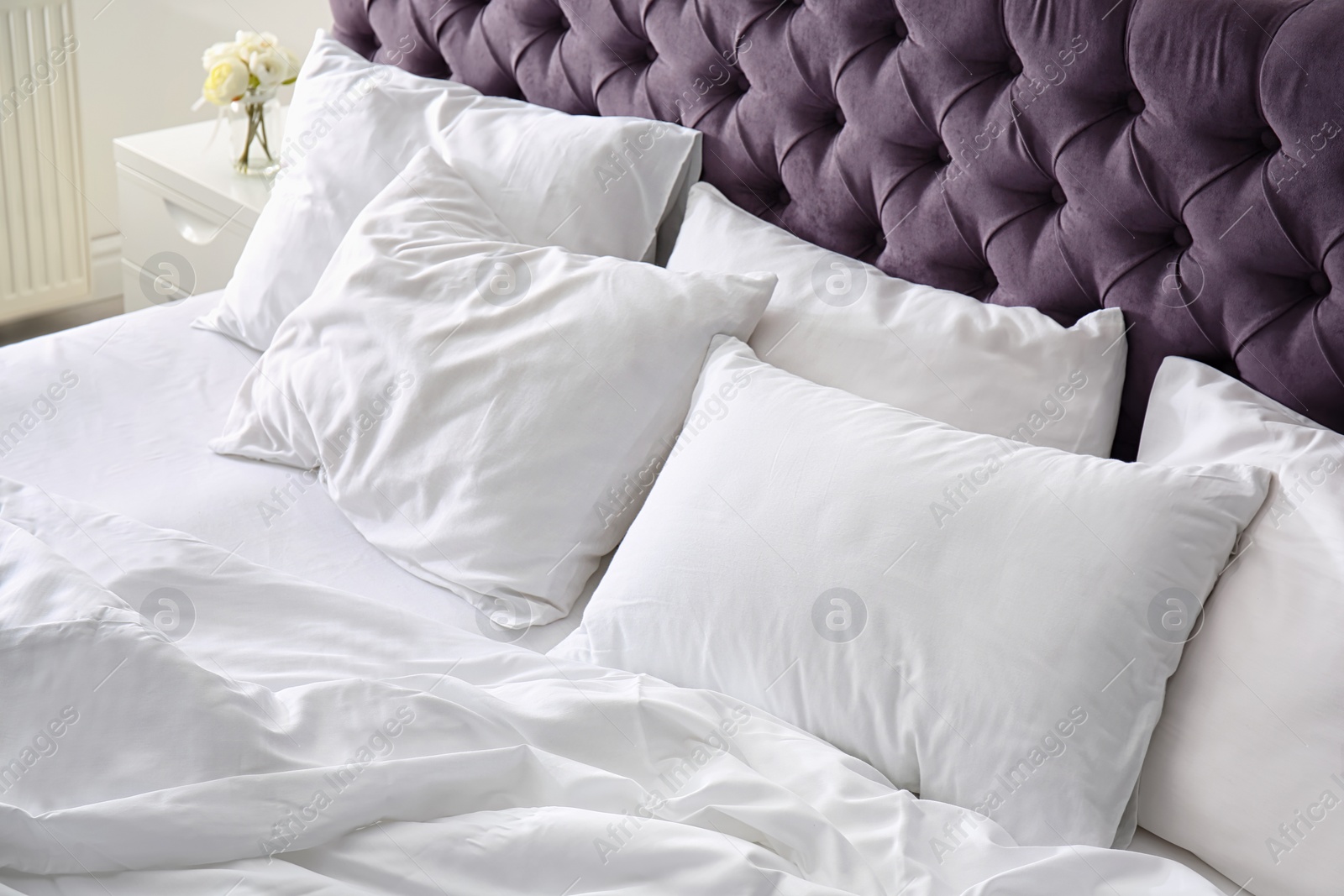 Photo of Comfortable bed with white linen at home