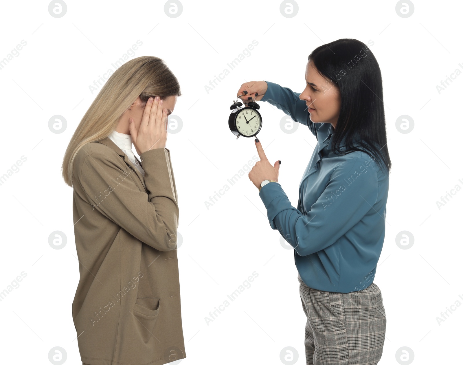 Photo of Businesswoman with alarm clock scolding employee for being late on white background