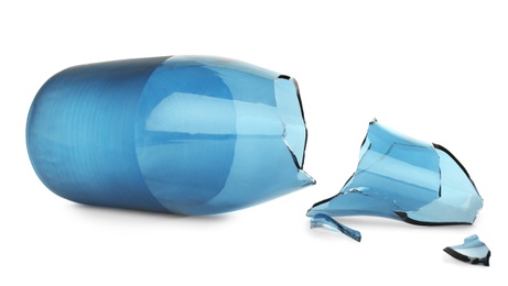 Broken blue glass vase isolated on white