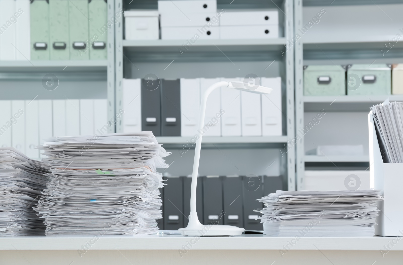 Photo of Stacks of documents on table in office