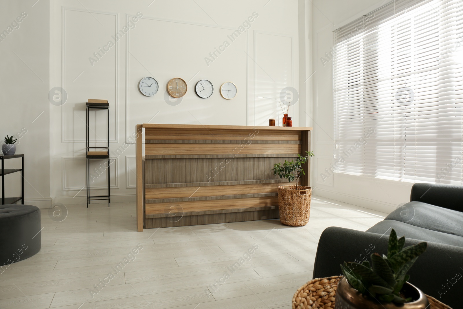 Photo of Hotel lobby interior with wooden reception desk. Stylish workplace