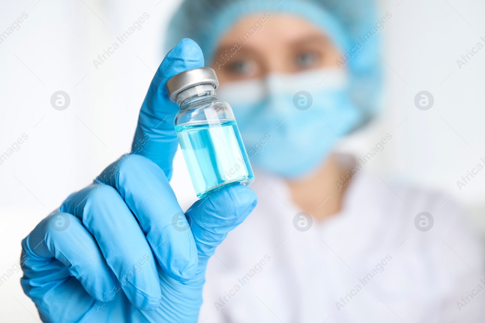 Photo of Doctor holding vial with medication, closeup. Vaccination and immunization