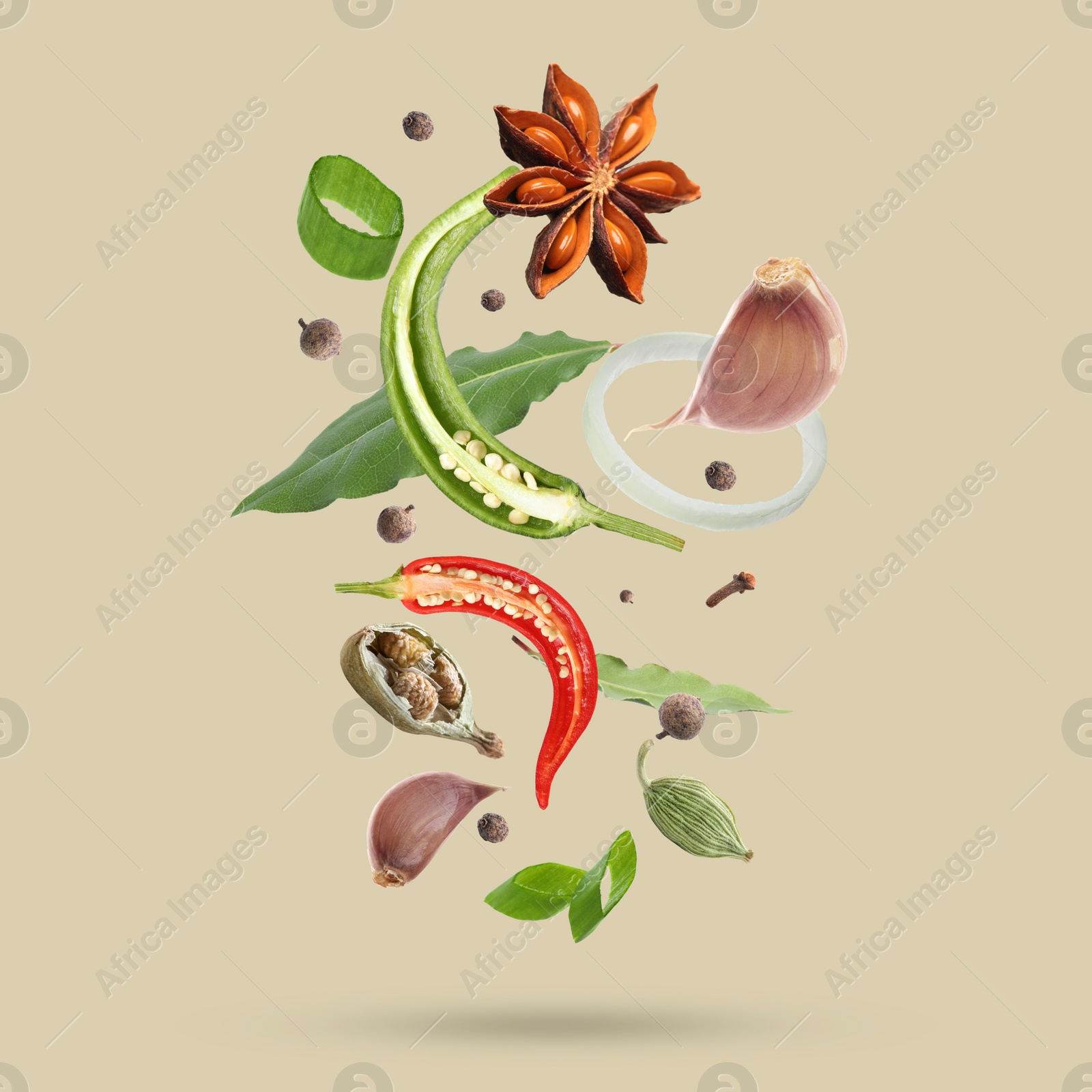 Image of Different spices falling on dark beige background