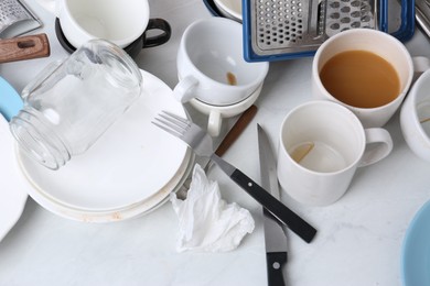 Photo of Many dirty utensils and dishware on countertop in messy kitchen, above view