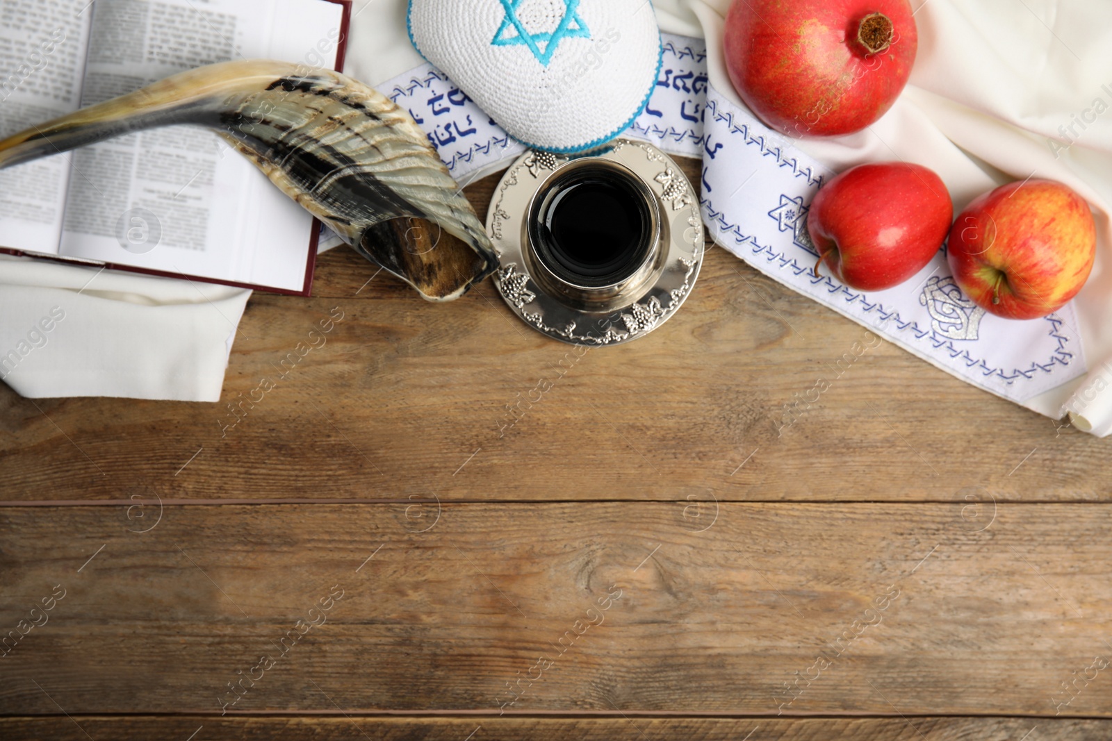 Photo of Flat lay composition with Rosh Hashanah holiday attributes on wooden table. Space for text