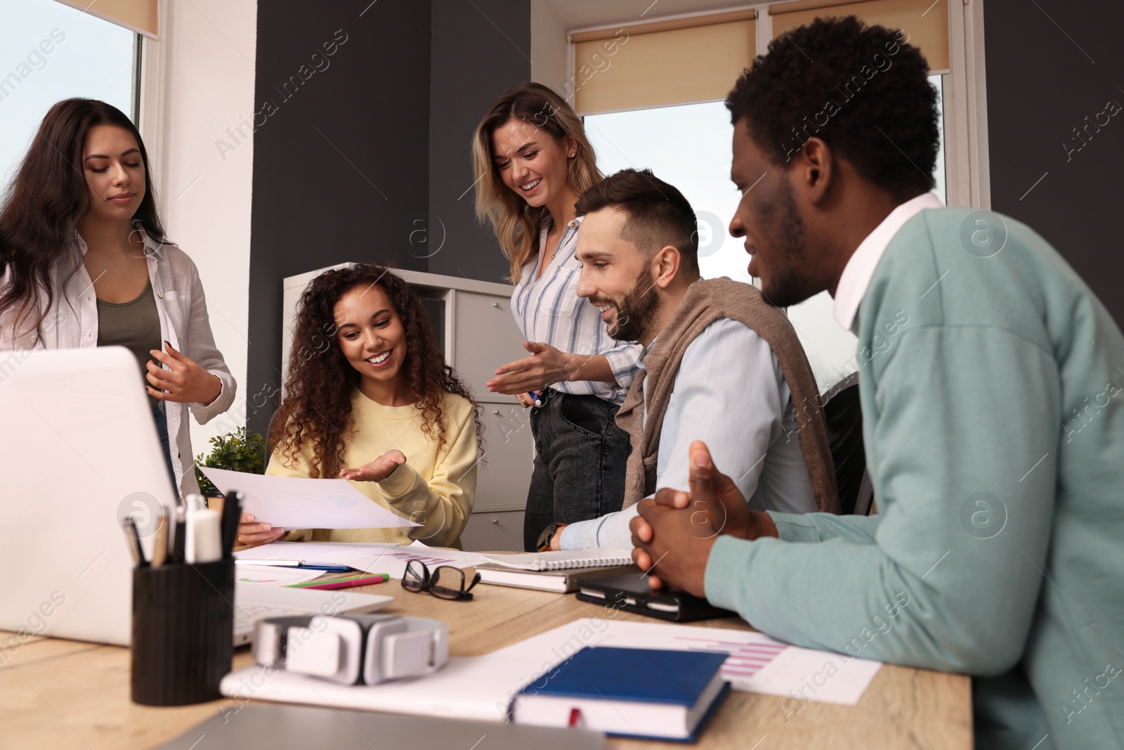 Photo of Team of employees working together in office. Startup project