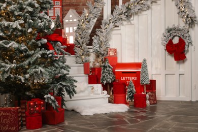 Christmas tree, gift boxes and festive decor indoors. Interior design