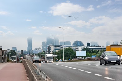 Photo of City road with cars on sunny day