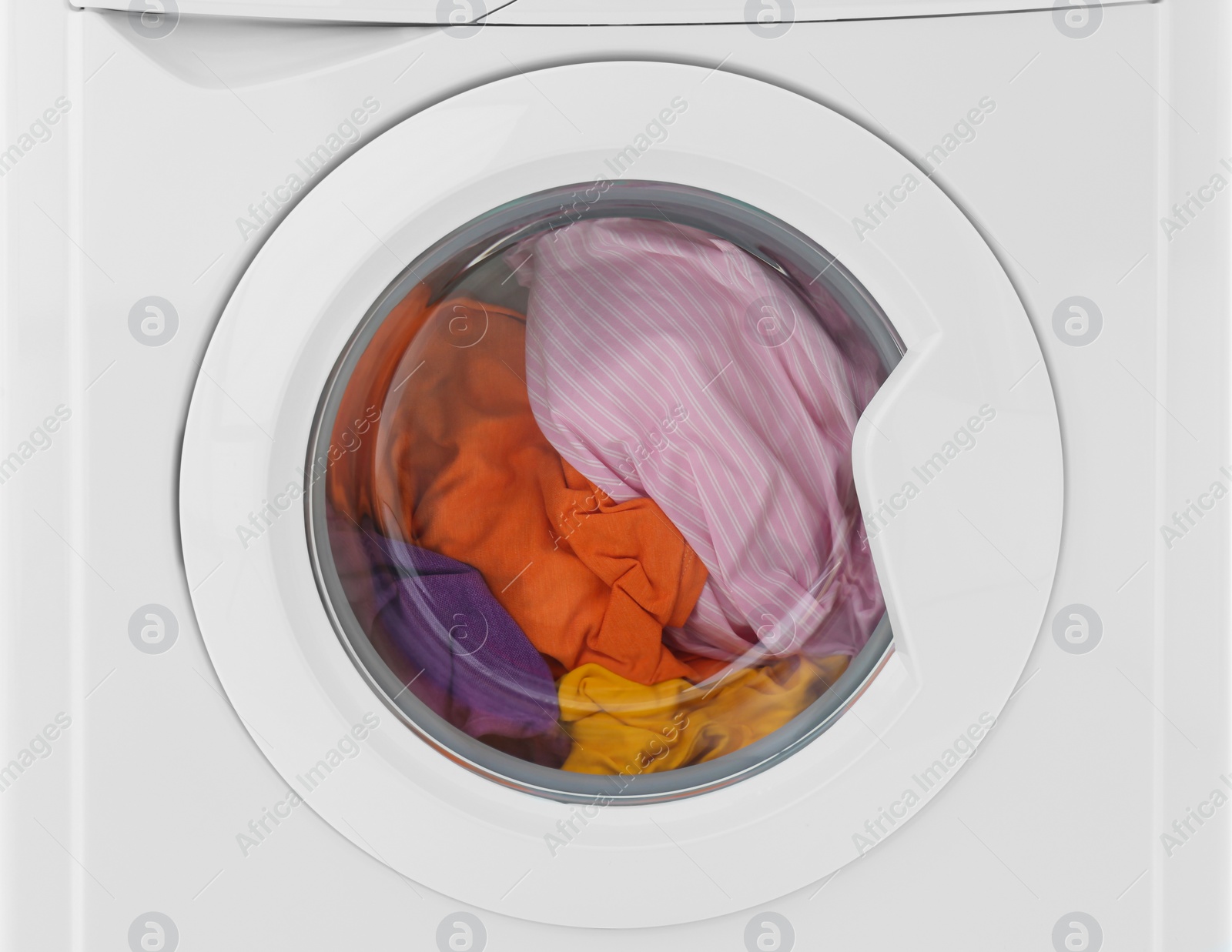 Photo of Modern washing machine with laundry isolated on white, closeup