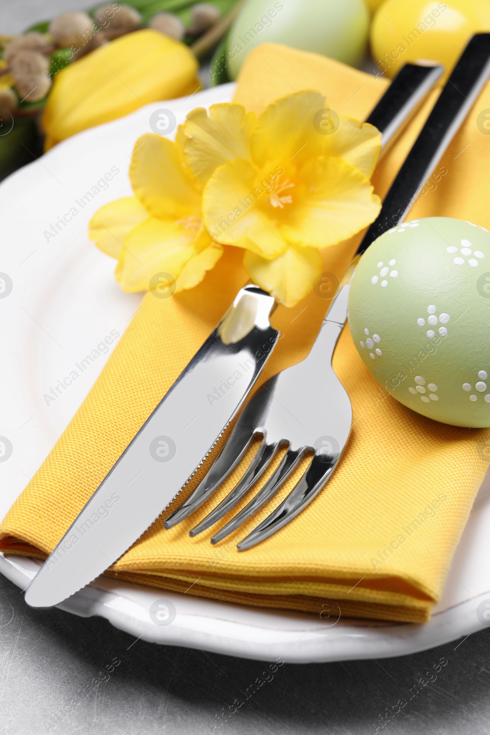 Photo of Festive Easter table setting with eggs on grey background, closeup