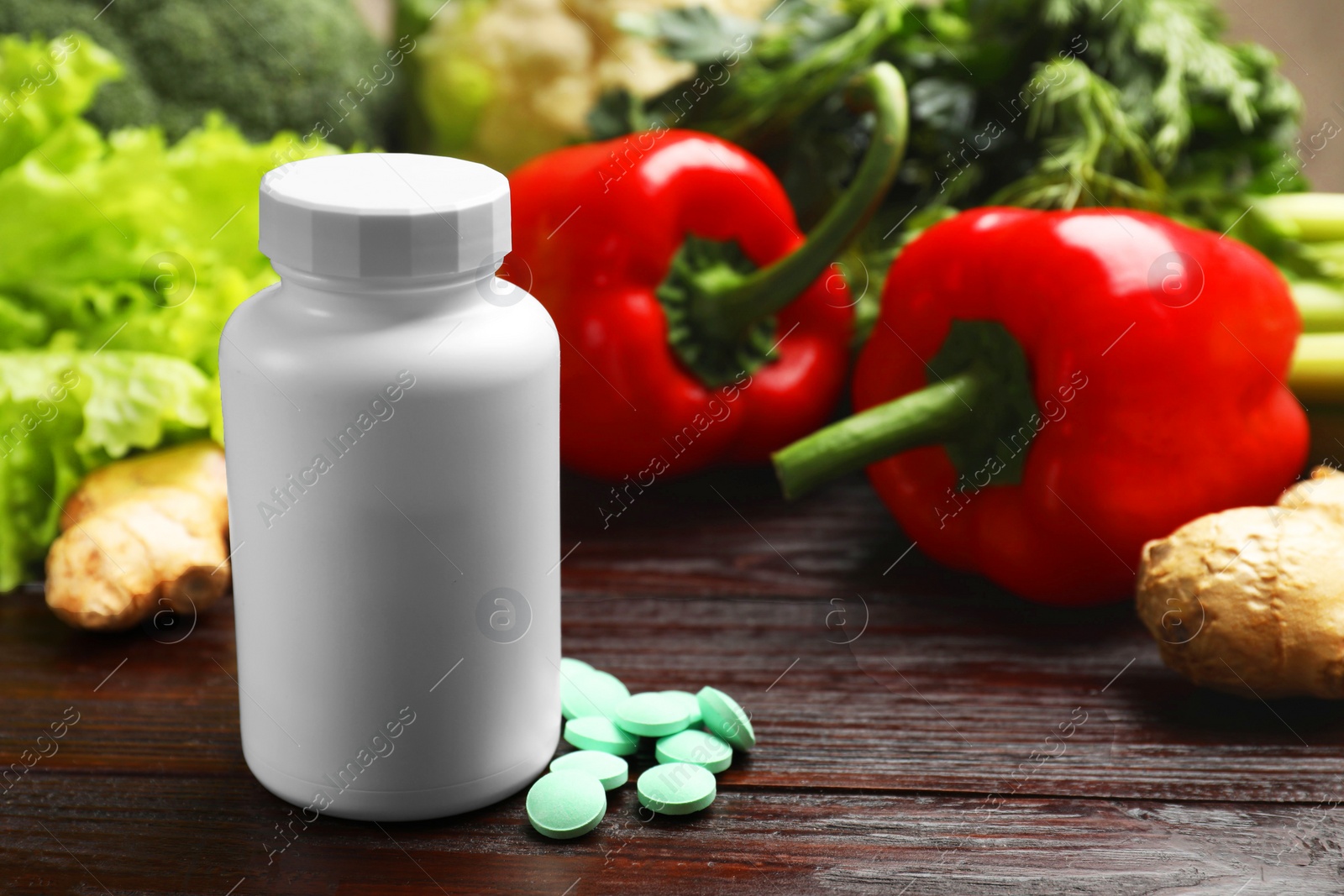 Photo of Dietary supplements. Plastic bottle, pills and food products on wooden table