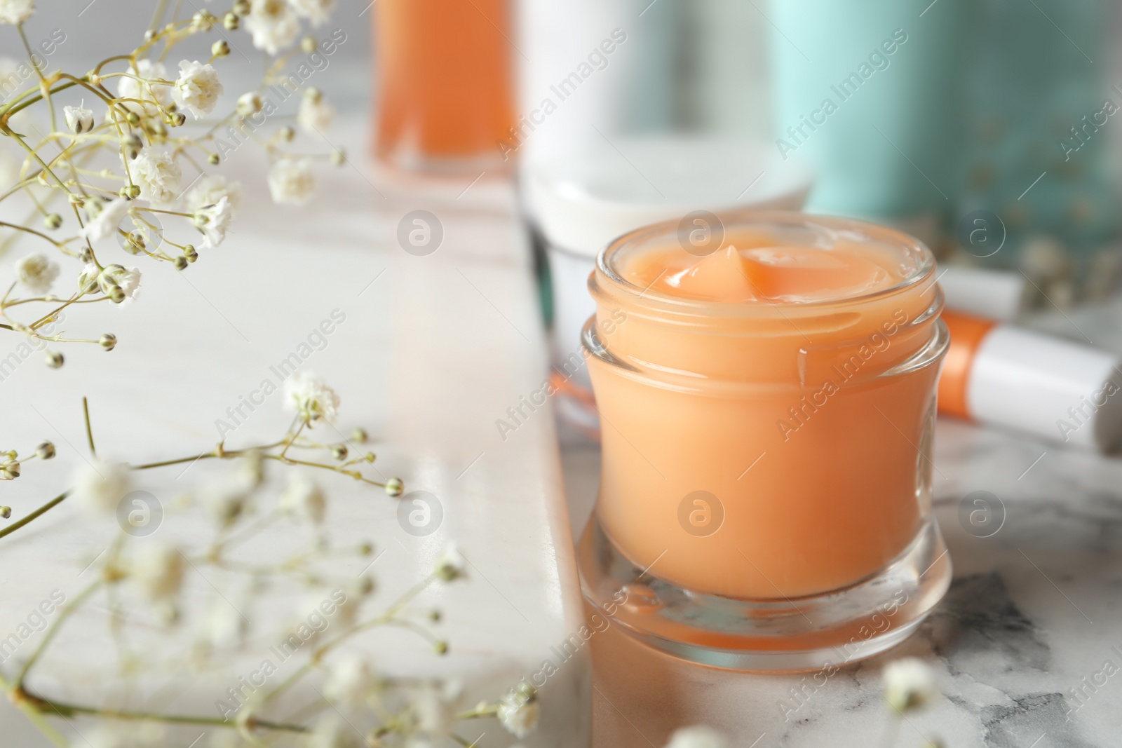 Photo of Set of luxury cosmetic product on white marble table, closeup