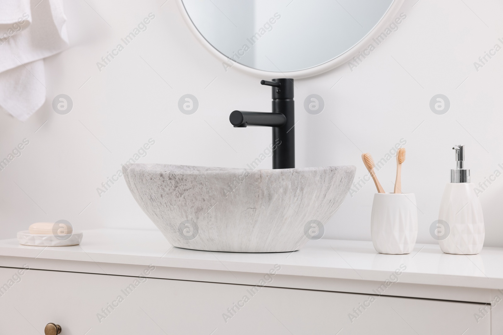 Photo of Different bath accessories and personal care products on bathroom vanity indoors