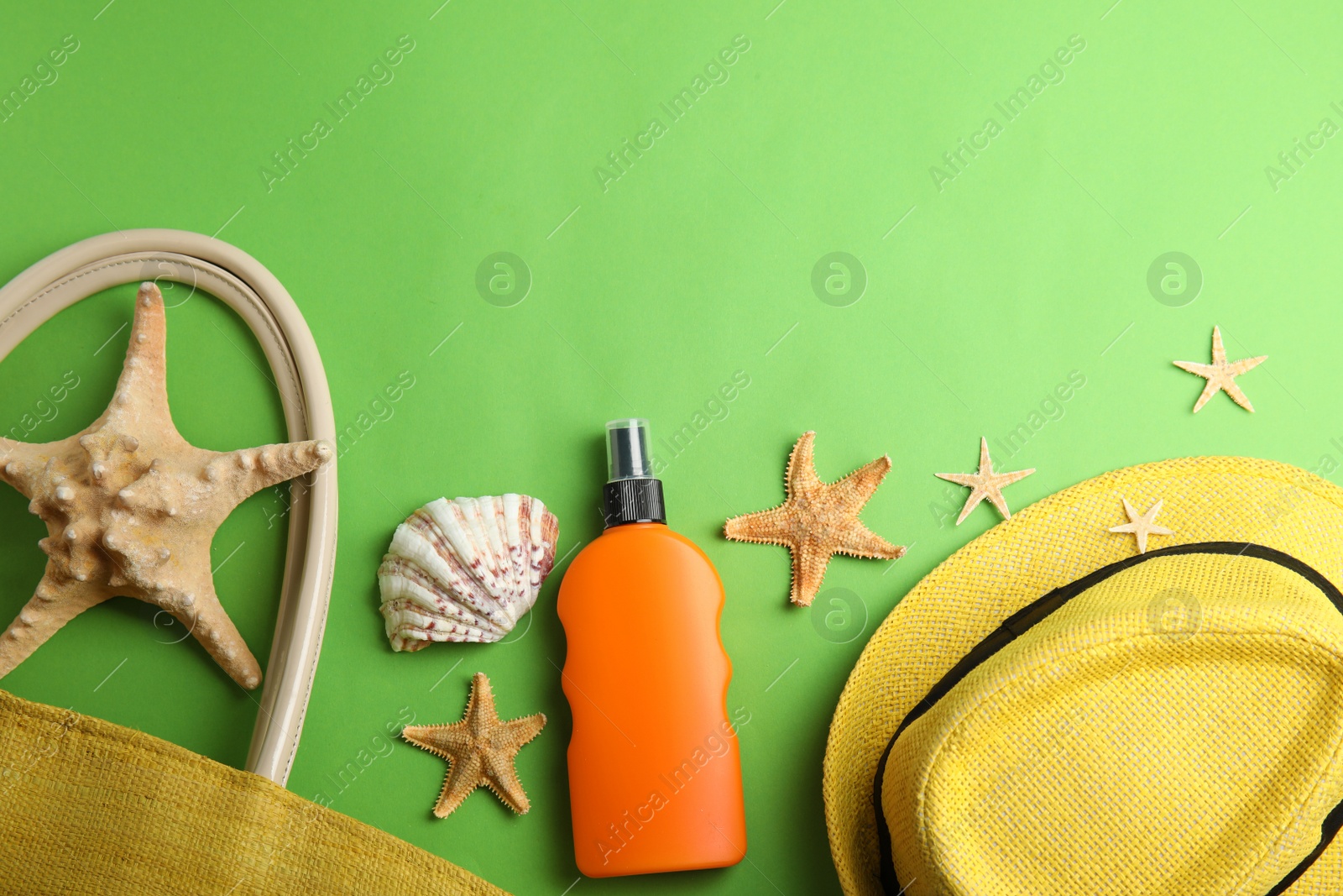 Photo of Flat lay composition with beach objects on green background. Space for text