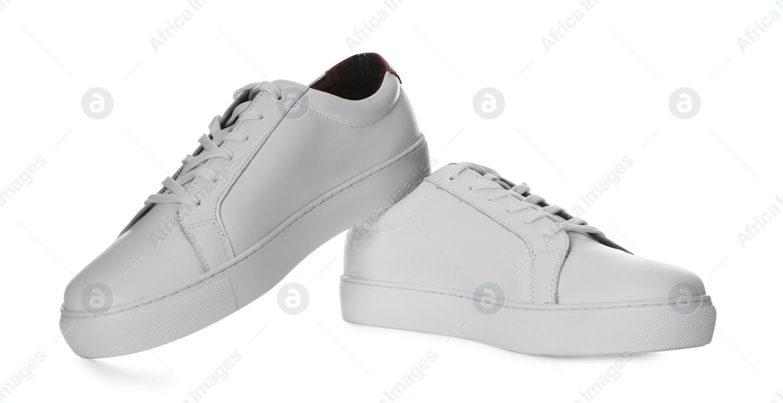 Photo of Pair of stylish sports shoes on white background