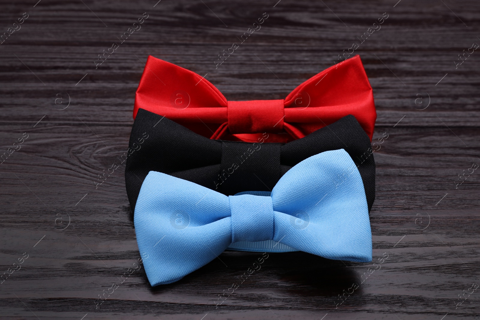 Photo of Different stylish bow ties on wooden table