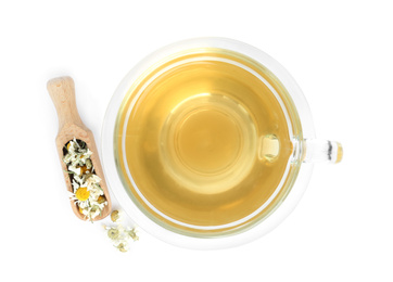 Photo of Fresh chamomile tea and dry flowers in scoop isolated on white, top view