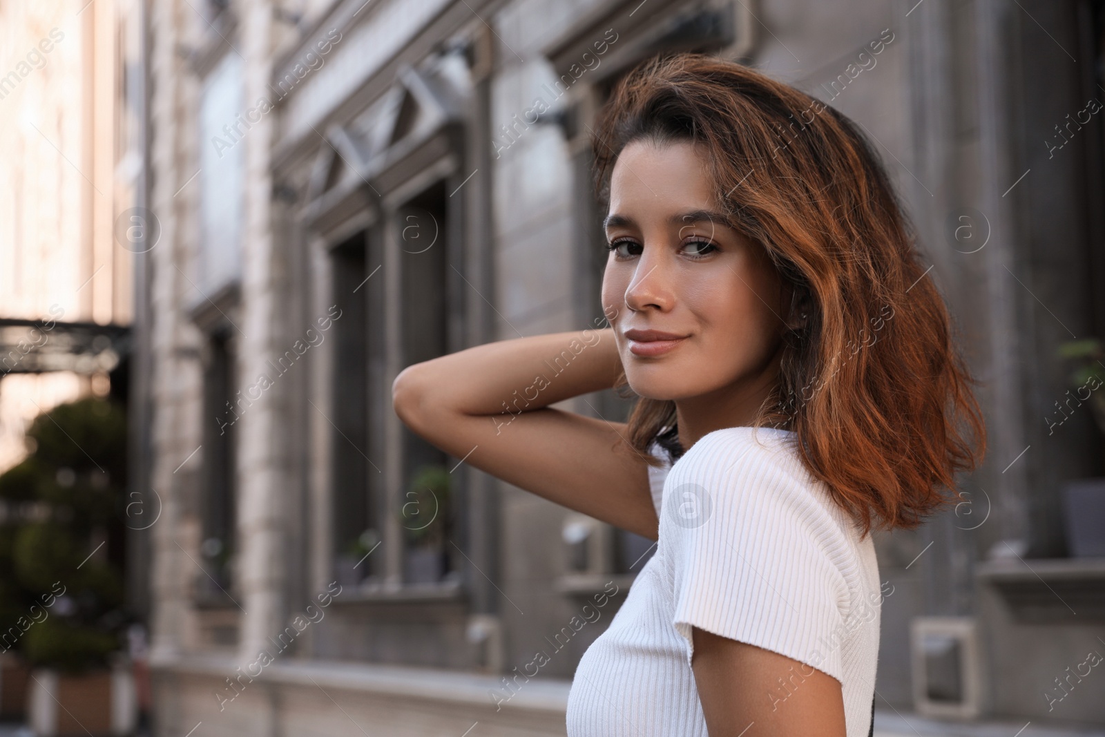 Photo of Portrait of beautiful young woman on city street