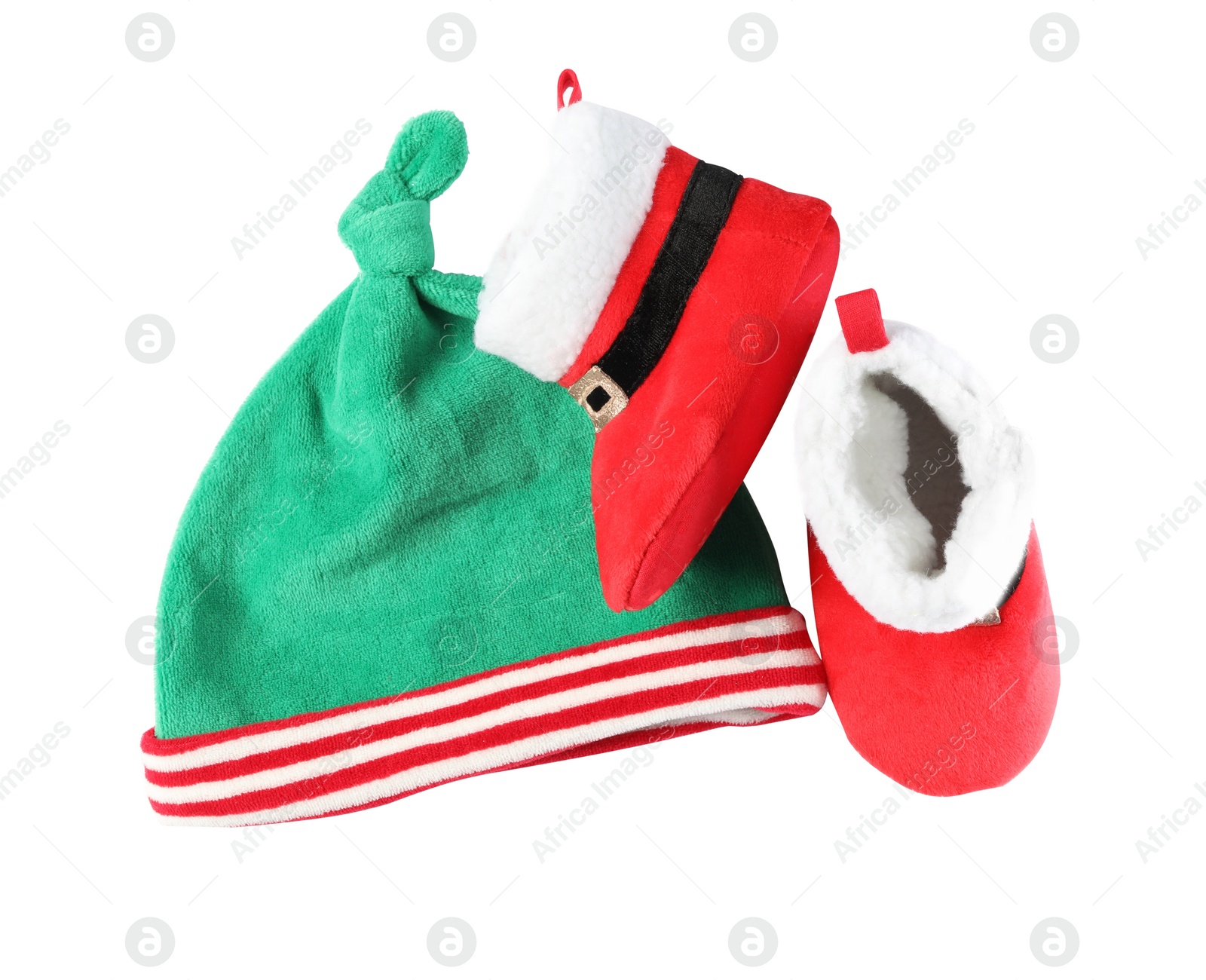 Photo of Cute small elf hat and booties on white background, top view. Christmas baby clothes