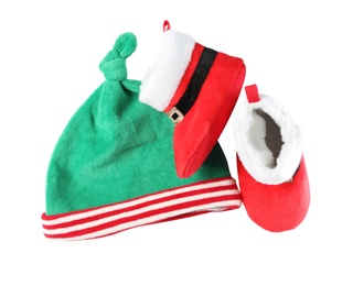Photo of Cute small elf hat and booties on white background, top view. Christmas baby clothes
