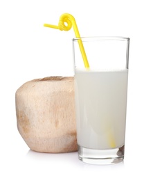 Photo of Glass of drink and peeled coconut on white background