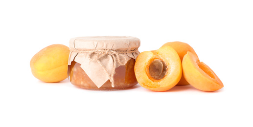 Photo of Jar of apricot jam and fresh fruits on white background