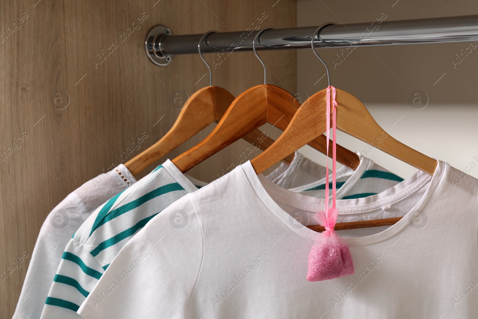 Photo of Scented sachet and clothes hanging in wardrobe