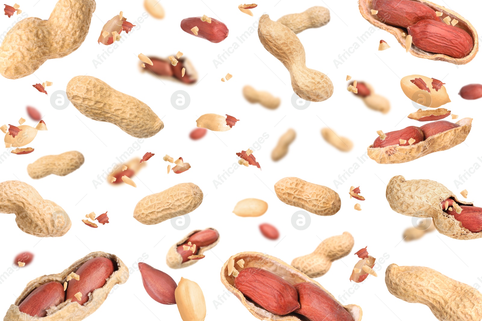 Image of Unpeeled peanuts in air on white background