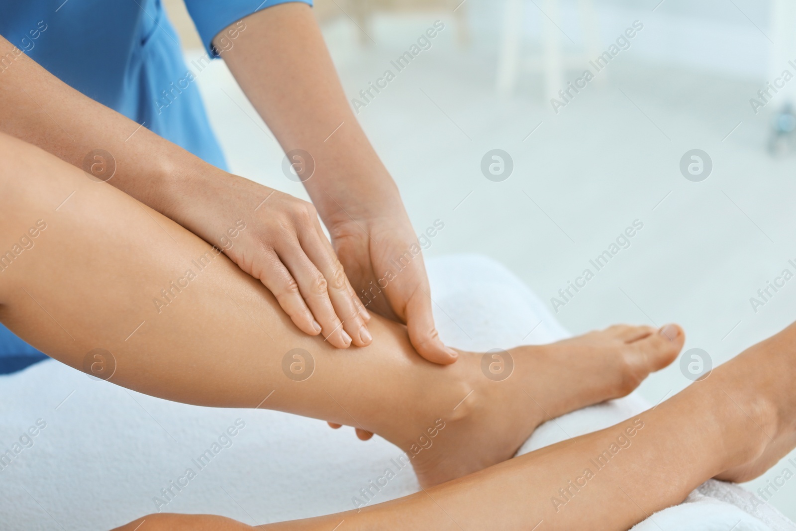 Photo of Woman receiving leg massage in wellness center, closeup