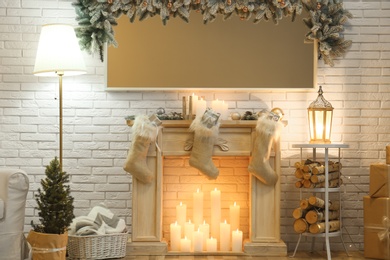 Room interior with mirror over fireplace decorated for Christmas