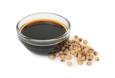 Tasty soy sauce in bowl and soybeans isolated on white