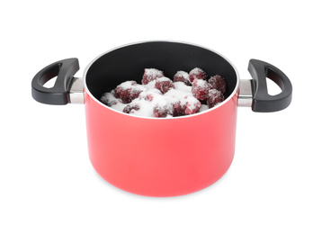 Pot with cherries and sugar on white background. Making delicious jam