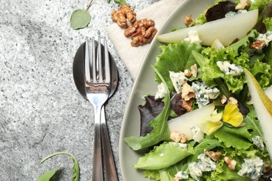 Photo of Fresh salad with pear on grey table, flat lay