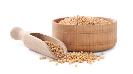 Photo of Mustard seeds with wooden bowl and scoop isolated on white