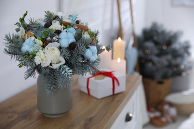 Photo of Beautiful wedding winter bouquet on chest of drawers indoors. Space for text