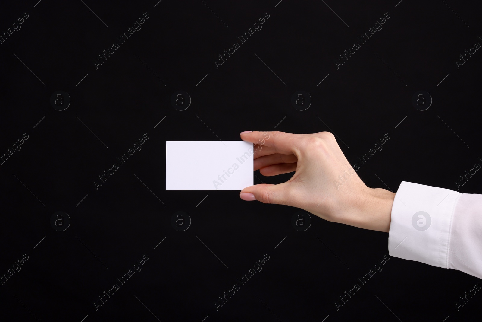 Photo of Woman holding blank business card on black background, closeup. Space for text
