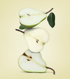 Image of Cut fresh ripe pears on beige background