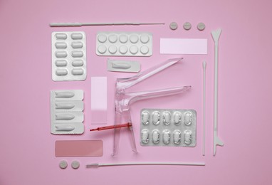 Sterile gynecological examination kit and medicaments on pink background, flat lay