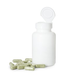 Photo of Bottle and pile of vitamin pills isolated on white