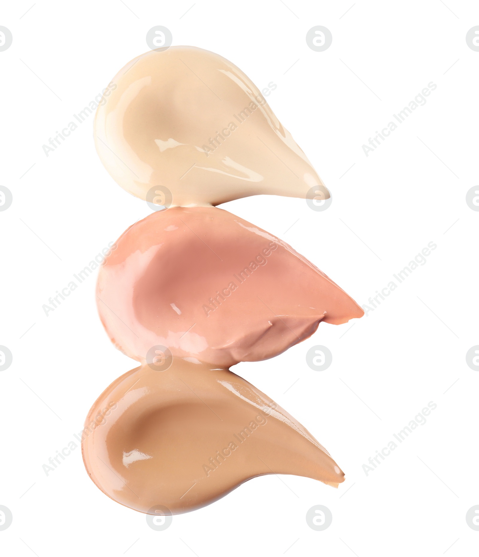 Photo of Different shades of liquid foundation on white background. Professional makeup products