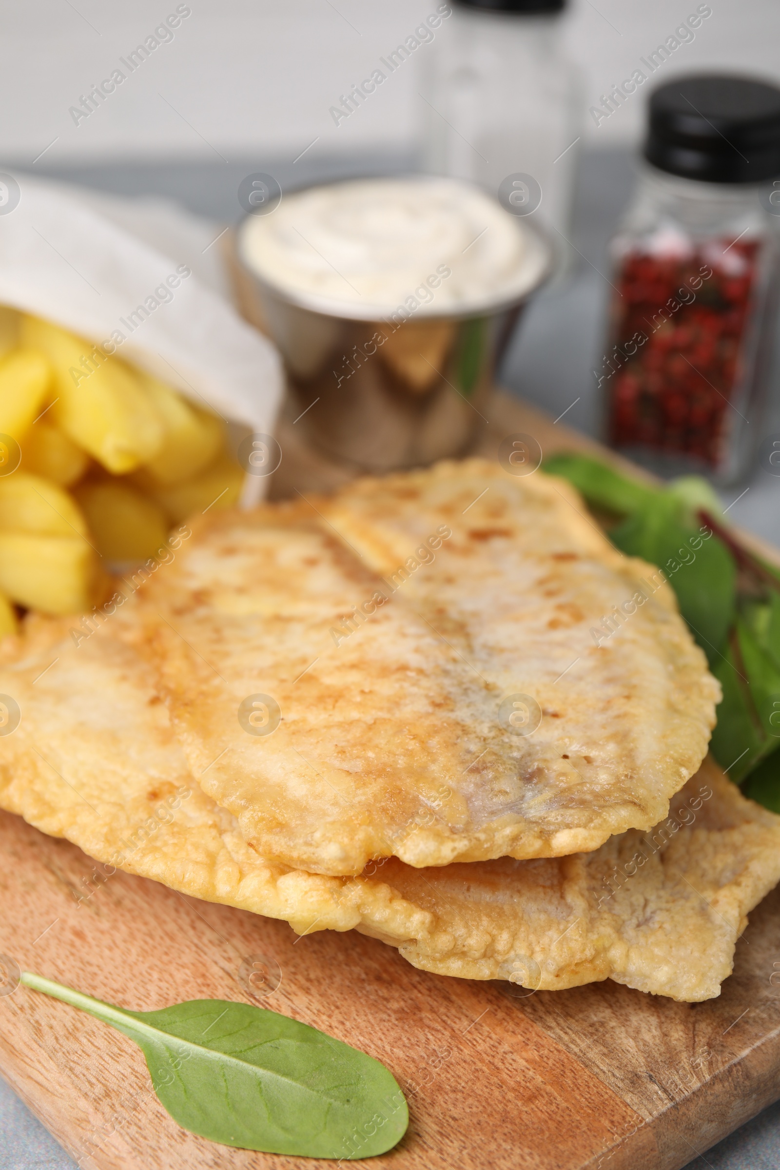 Photo of Delicious fish and chips with mangold on table, closeup