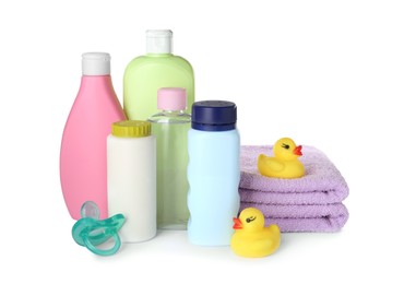 Photo of Bottles of baby cosmetic products, towels, pacifier and rubber ducks on white background