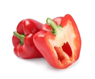 Whole and cut red bell peppers on white background