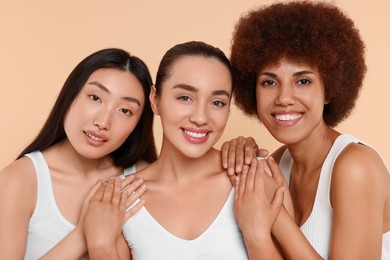 Photo of Portrait of beautiful young women on beige background