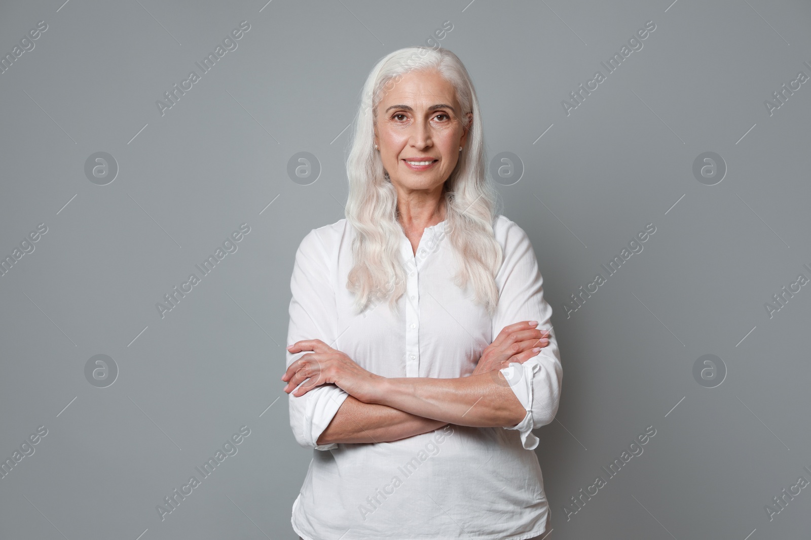 Photo of Portrait of beautiful mature woman on grey background