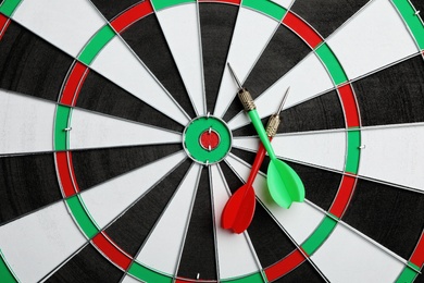 Photo of Dart board with color arrows, top view. Space for text