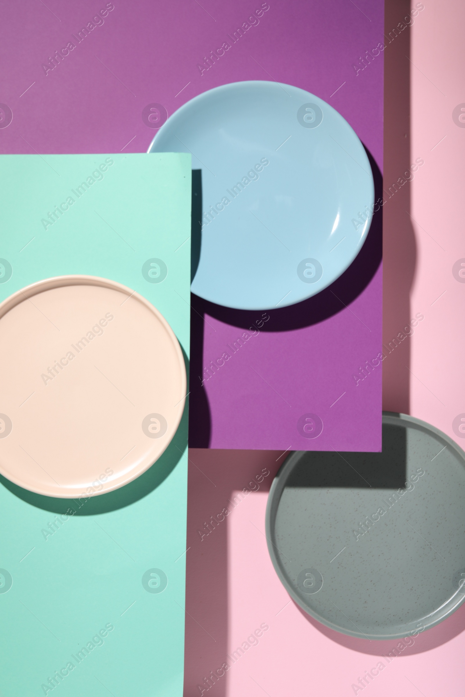 Photo of Abstract composition made of plates on color background, flat lay